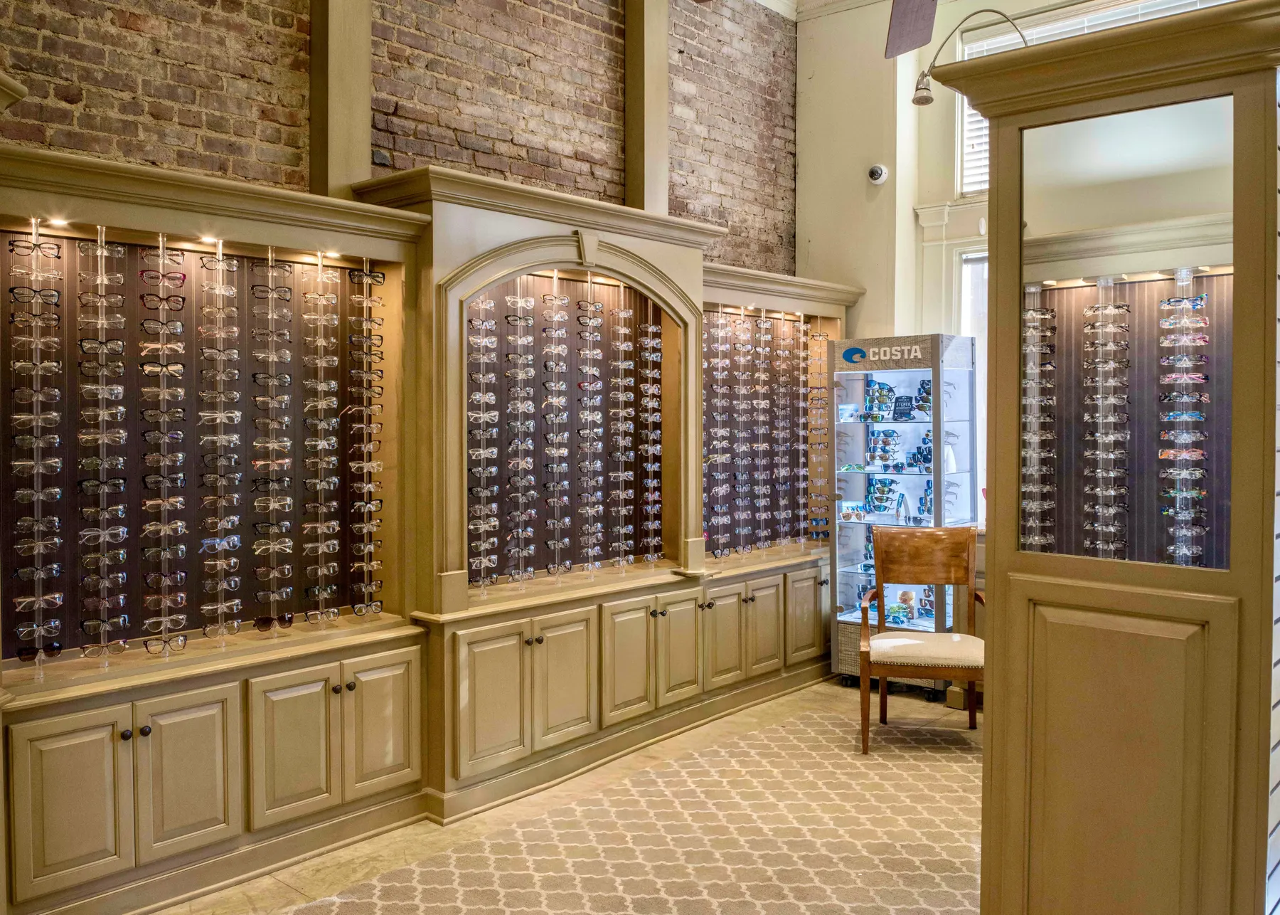 Walls of designer frames in the optical boutique at Wood Eye Clinic